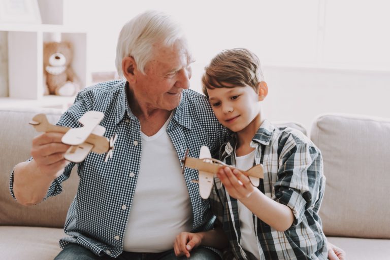 Castlewoods Place | Senior and grandson playing with model planes