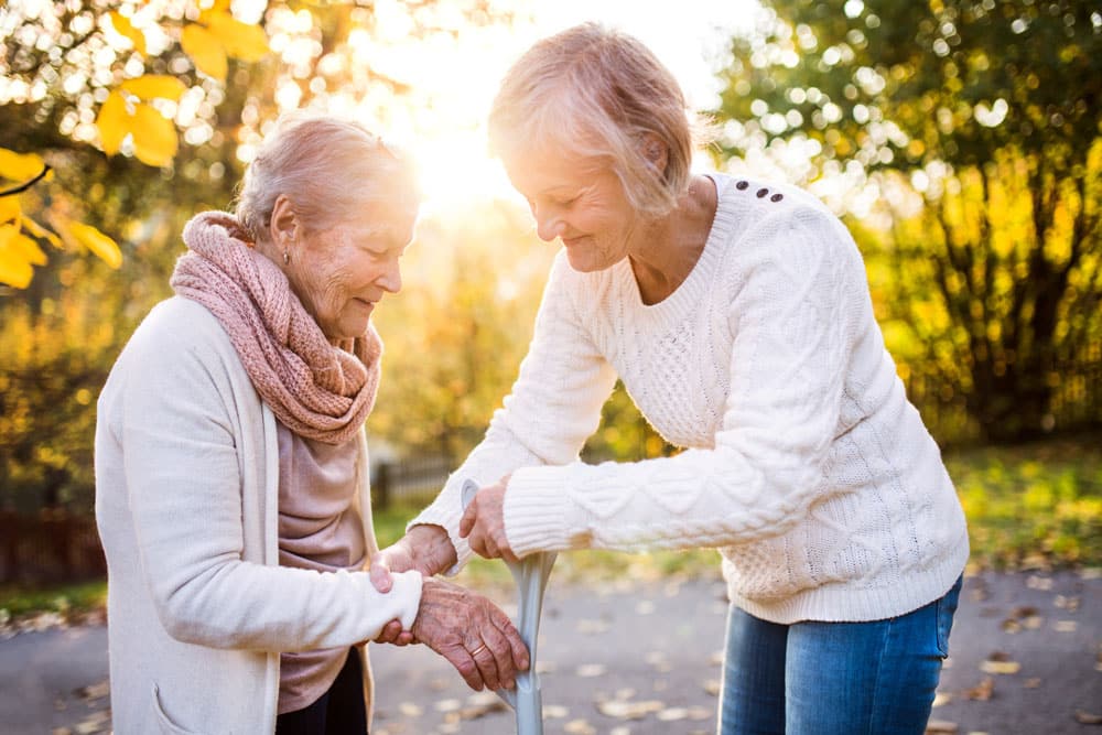 The Farrington at Tanglewood | Woman handing a cane to her aging mother