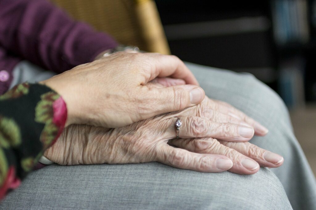 The Farrington at Tanglewood | Senior holding hands with caregiver