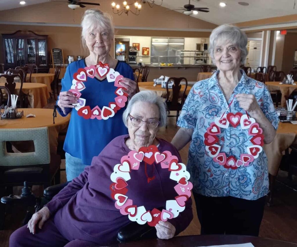 Chisholm Trail Estates | Seniors showing their valentine's crafts