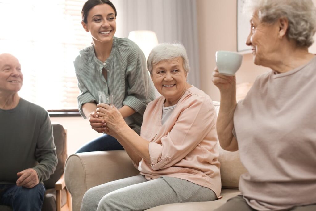 Pegasus Senior Living | Seniors Chatting On A sofa