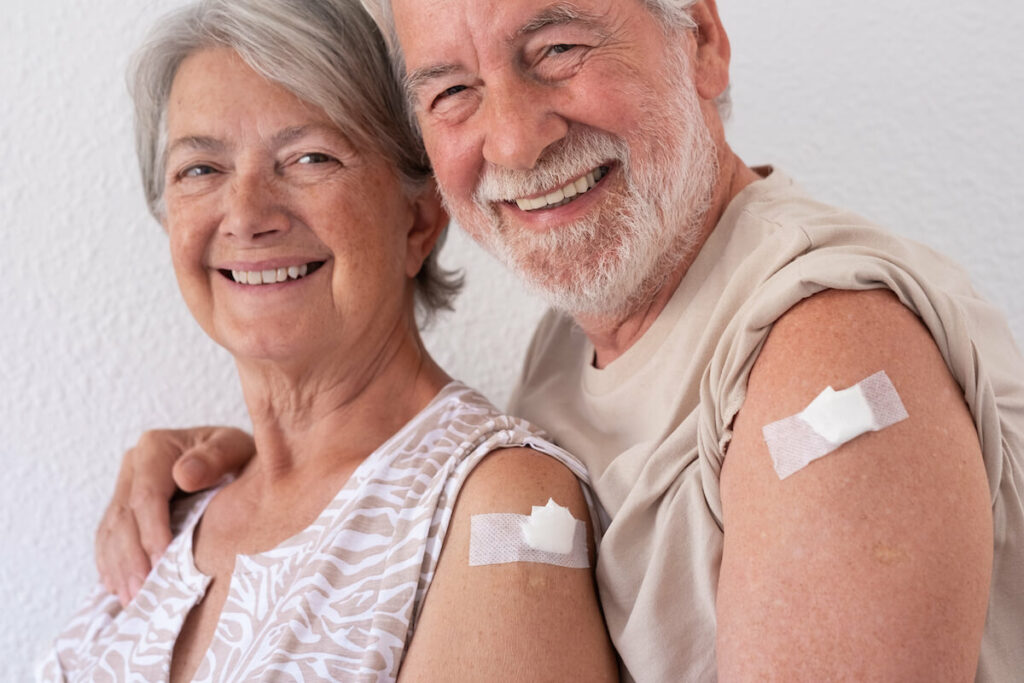 Pegasus Senior Living | Senior couple smiling after getting a vaccine shot