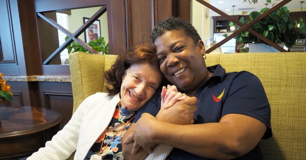 Pegasus Senior Living | Senior resident and staff member hugging