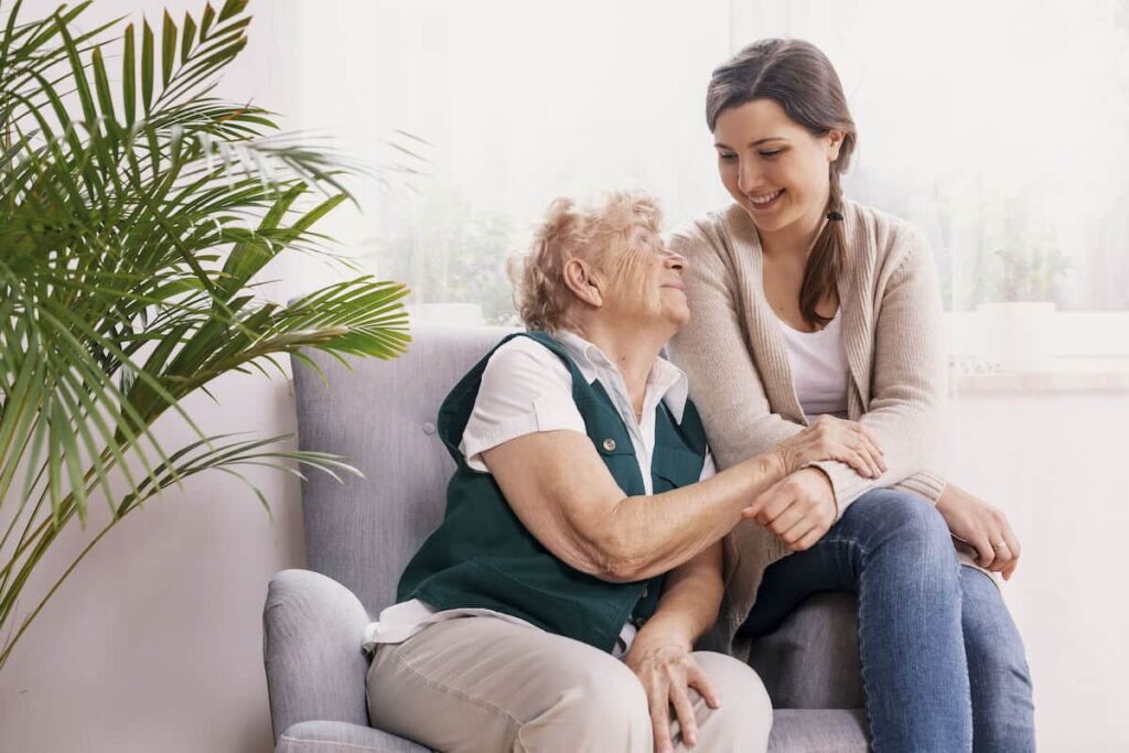 Parmer Woods at North Austin | Senior woman and her caregiver sitting on a chair