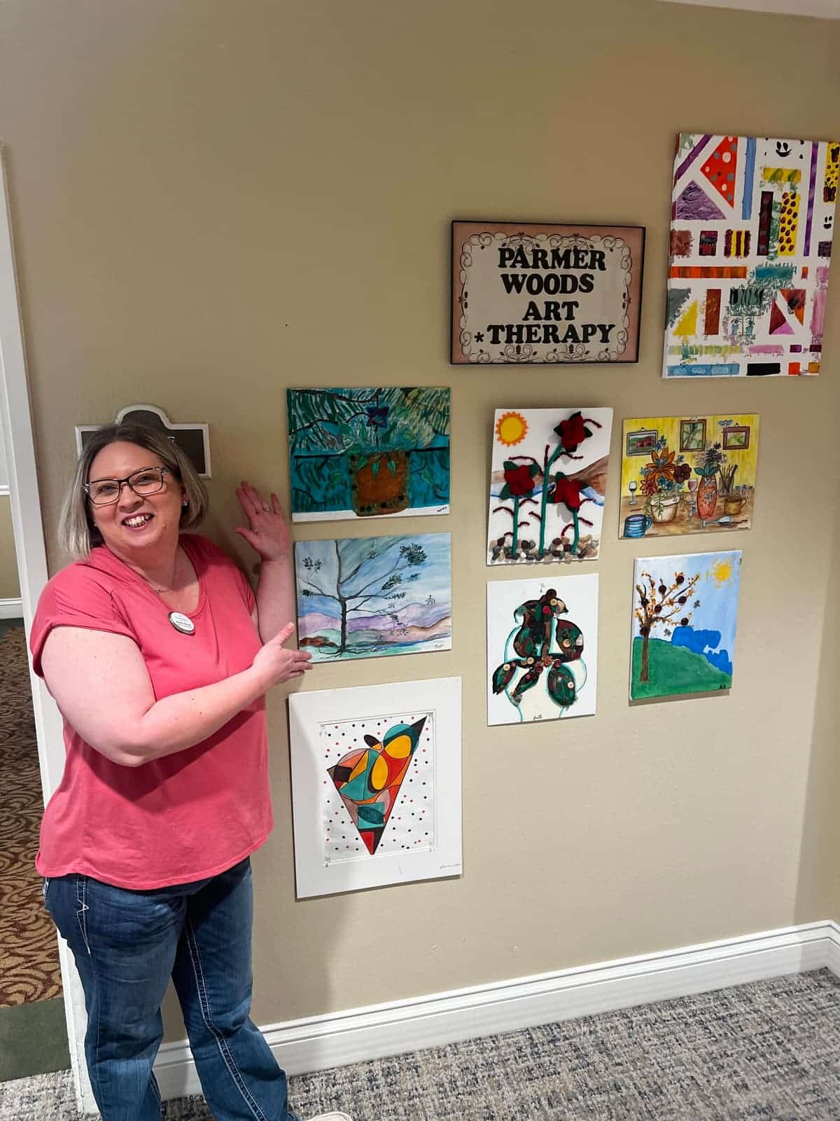 Parmer Woods at North Austin | Brandy showing off the residents' artwork