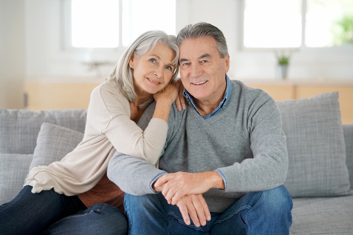 Pegasus Landing of Chisholm Trail | Senior couple sitting on a sofa