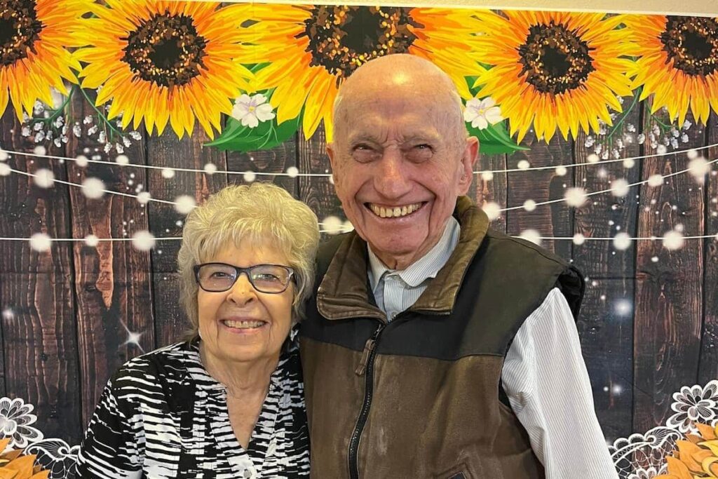 Pegasus Landing of Chisholm Trail | Seniors smiling in front of flowers