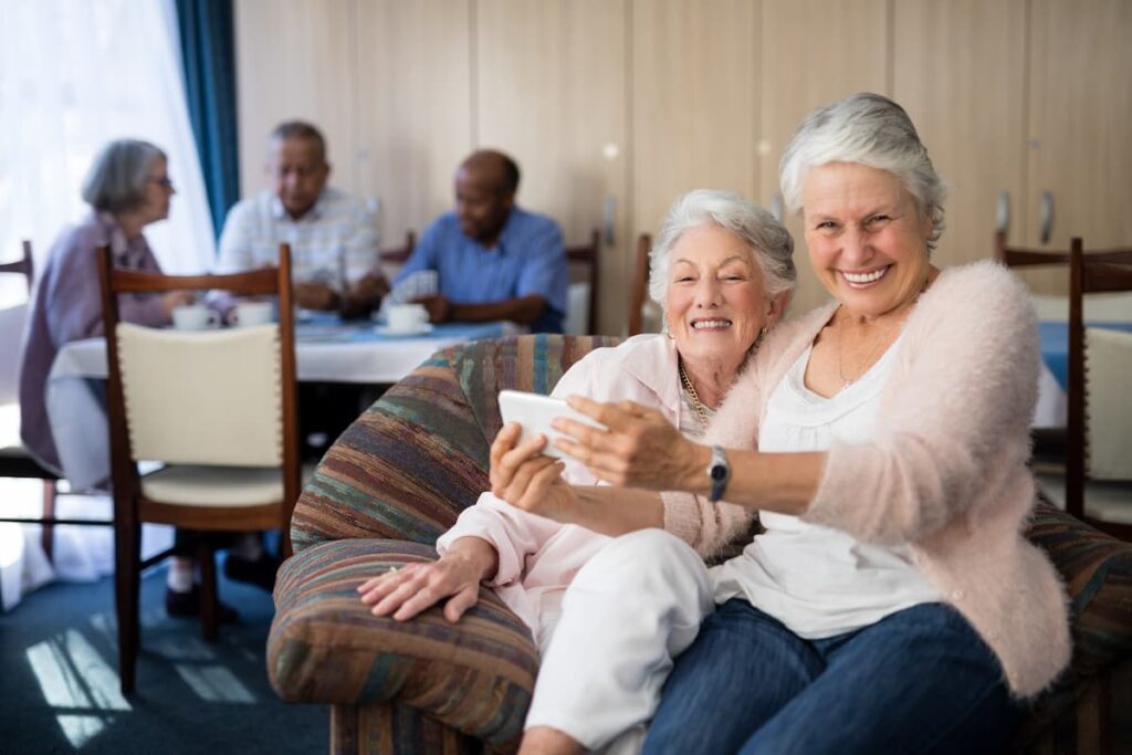 Pegasus Landing of Forney | Smiling Senior Woman Taking Selfie With Friend