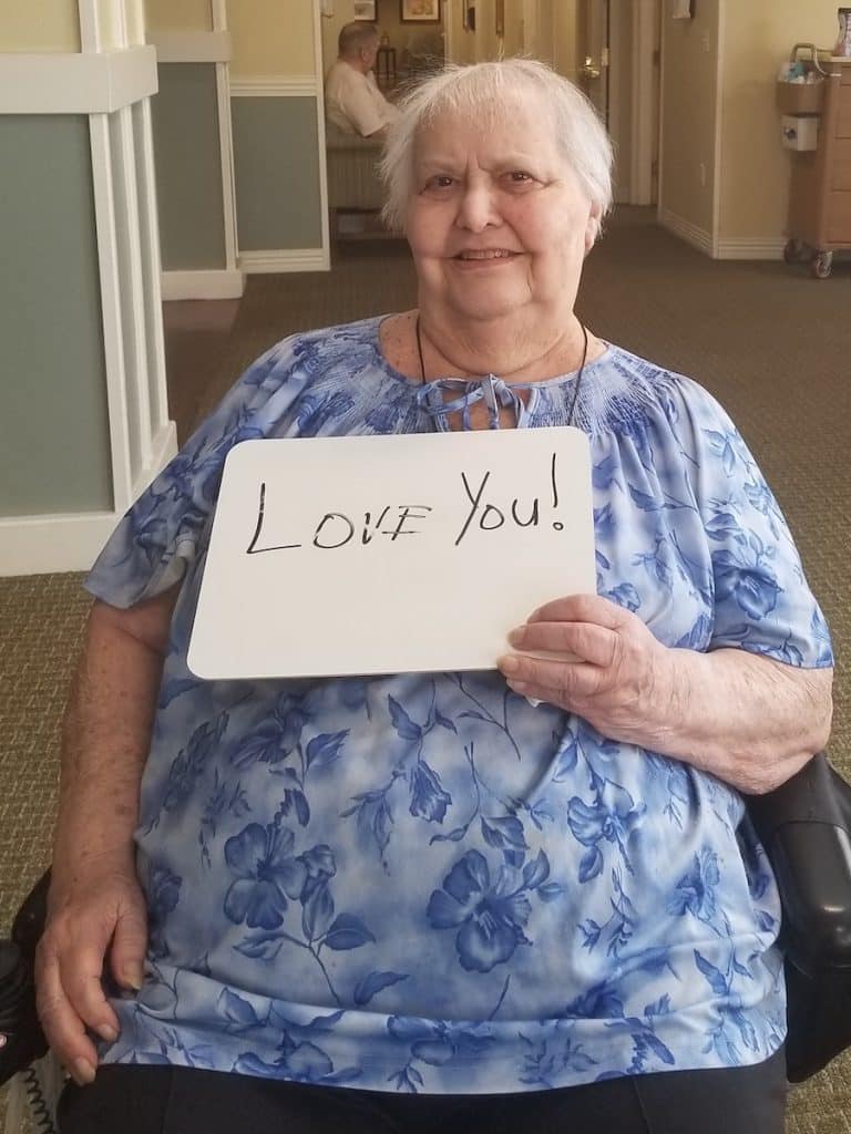 Pegasus Landing of Mesa | Resident holding sign