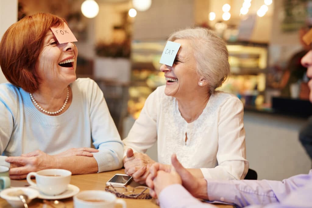 Pegasus Landing of Mesa | A group of seniors laughing and having fun playing games