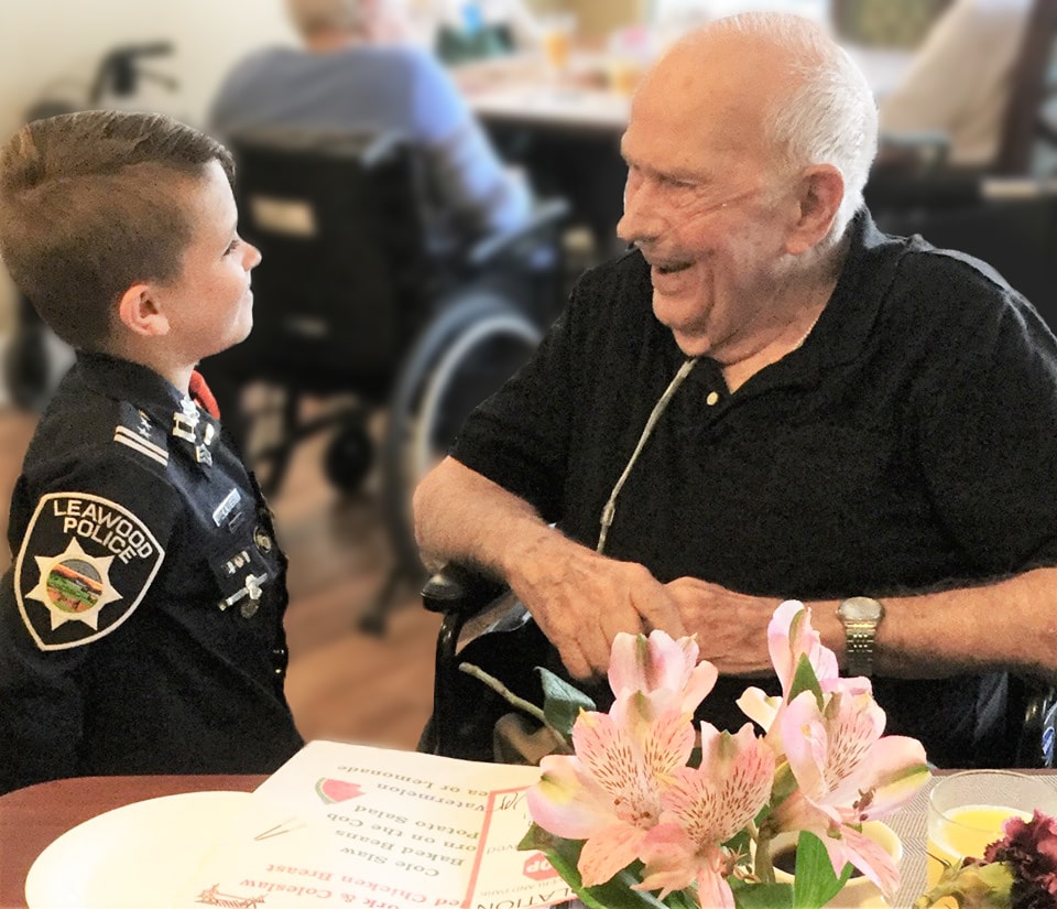 Pegasus Landing of Overland Park | Senior speaking to child in costume