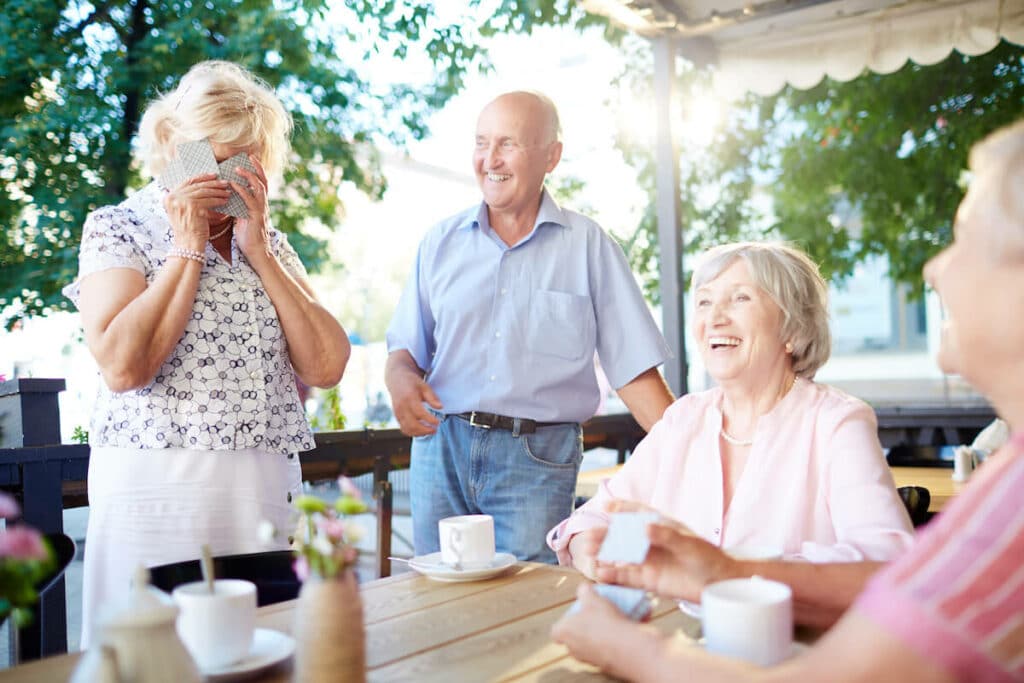 Pegasus Landing of Overland Park | Seniors laughing and playing cards