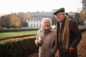 Pegasus Landing of Overland Park | Smiling senior couple out for a walk in chilly weather