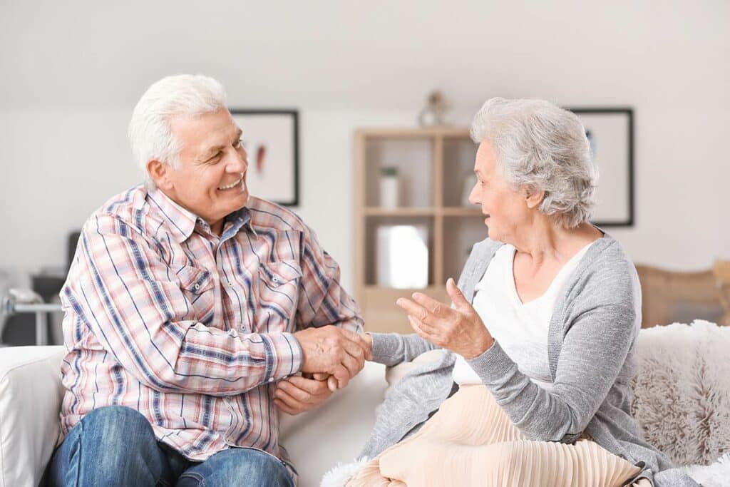 Pegasus Landing of Overland Park | Senior couple sitting on a couch and talking