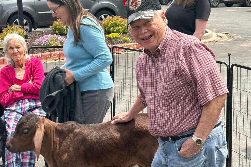 Pegasus Landing Overland Park | Senior petting a goat