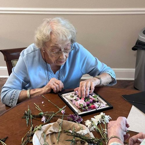 Pegasus Landing of Overland Park | Senior woman creating floral craft