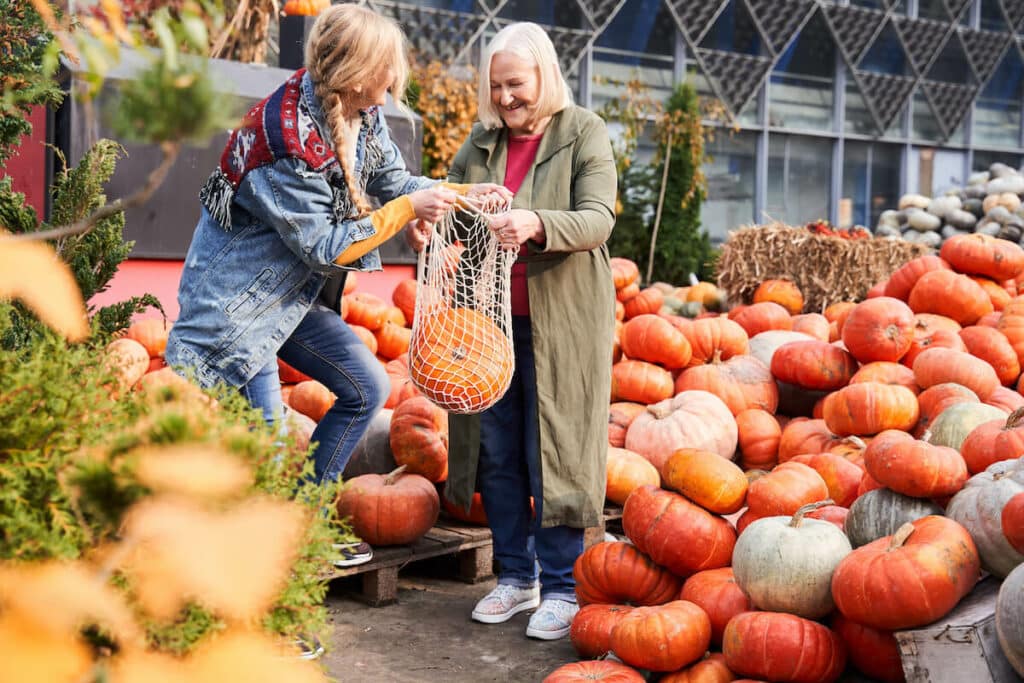 Pegasus Landing of Tanglewood | Senior shopping at a farmers market buying a pumpkin