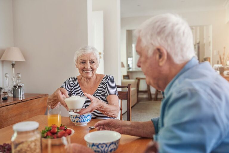 Pegasus Landing of Tanglewood | Happy seniors eating healthy food at dining table