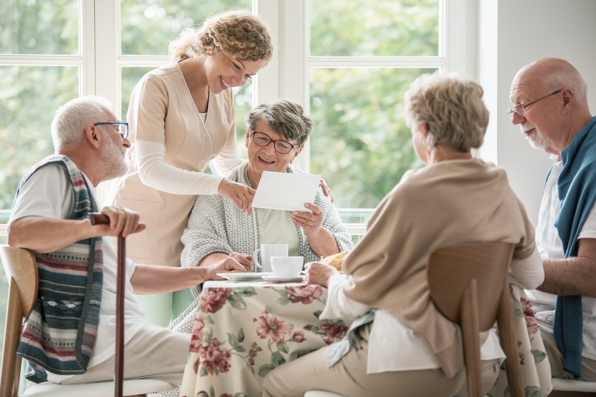 Landing of Tanglewood | Nurse showing a senior a photo