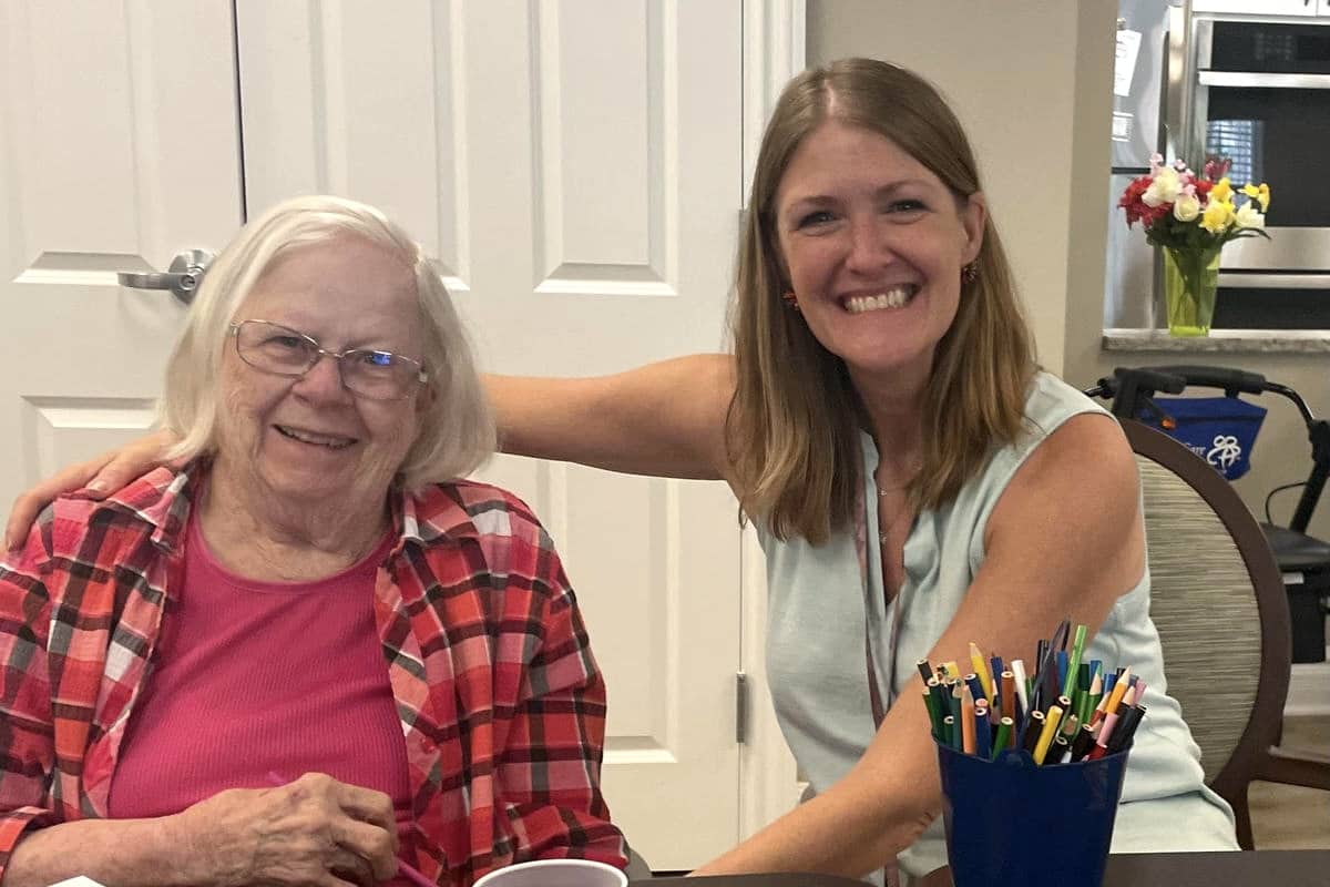 Courtyards at Mountain View | Molly sitting with a memory care resident