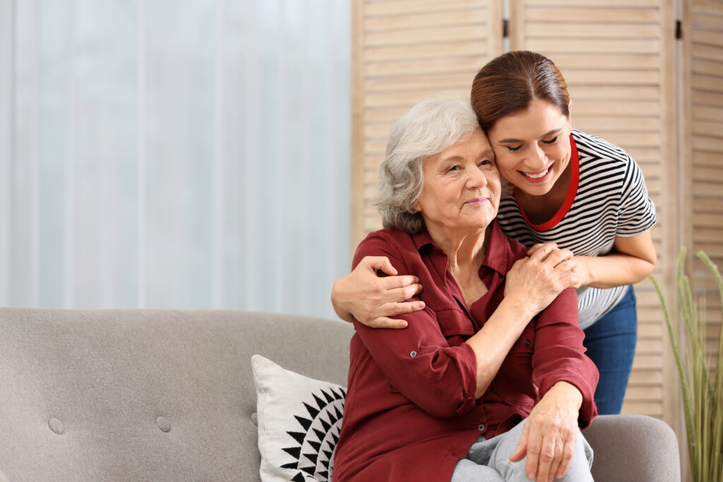 The Gardens at Marysville | Elderly woman with female caregiver in living room