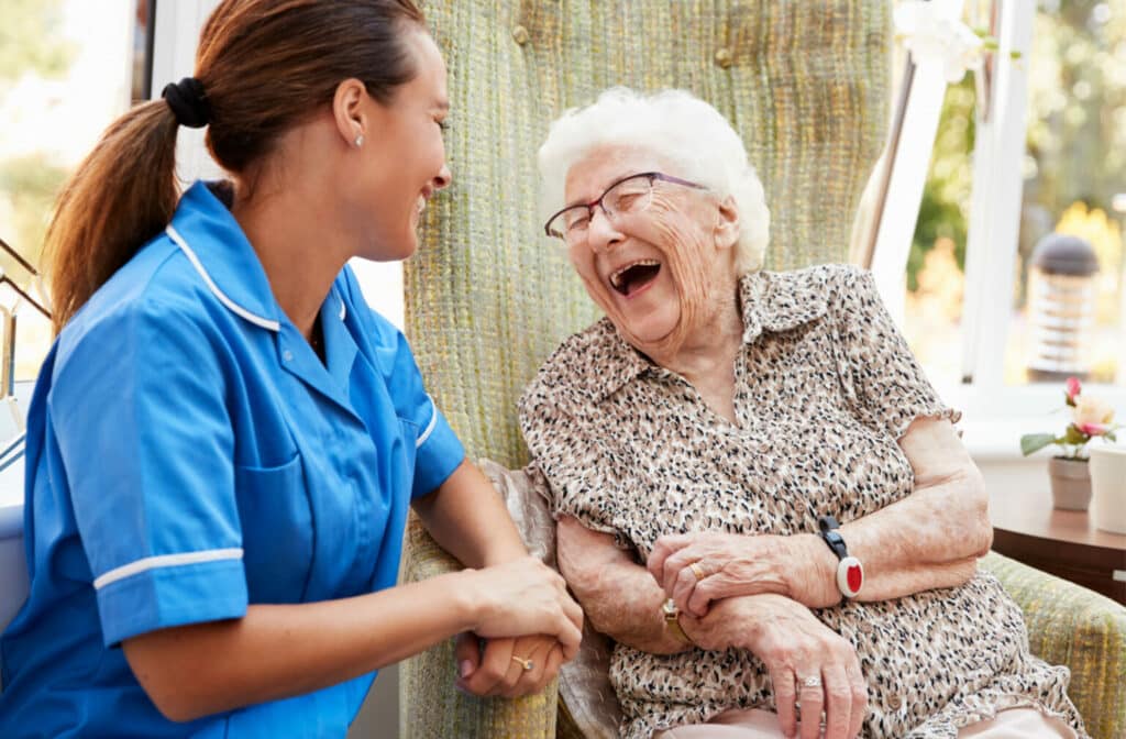 The Legacy at Cimarron in El Paso | Senior woman and caretaker laughing