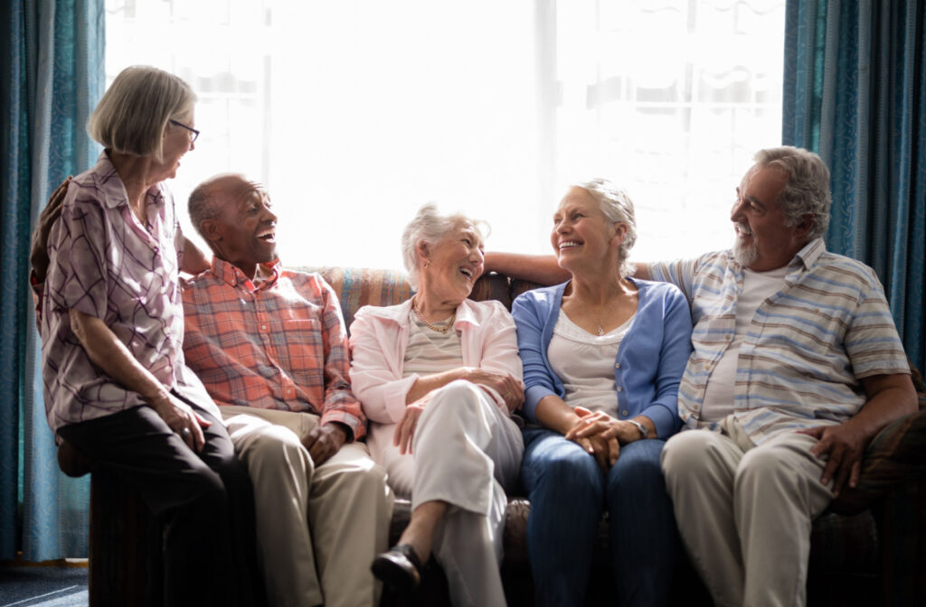 The Legacy at Crystal Falls in Leander | Older adults sitting on a sofa together