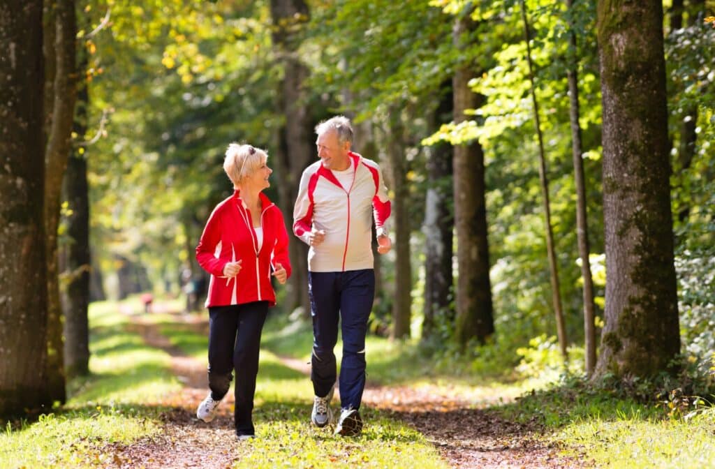 The Legacy at Crystal Falls in Leander | Senior couple jogging in the park