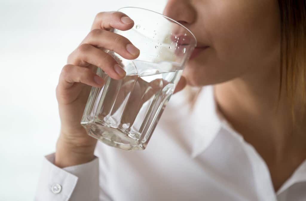 The Legacy At Falcon Point | A close-up of a woman drinking water in a glass.