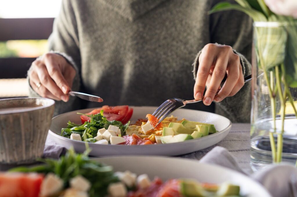 The Legacy At Falcon Point | Women eating a healthy meal of salmon, avocado, tomatoes, leafy greens and omelette