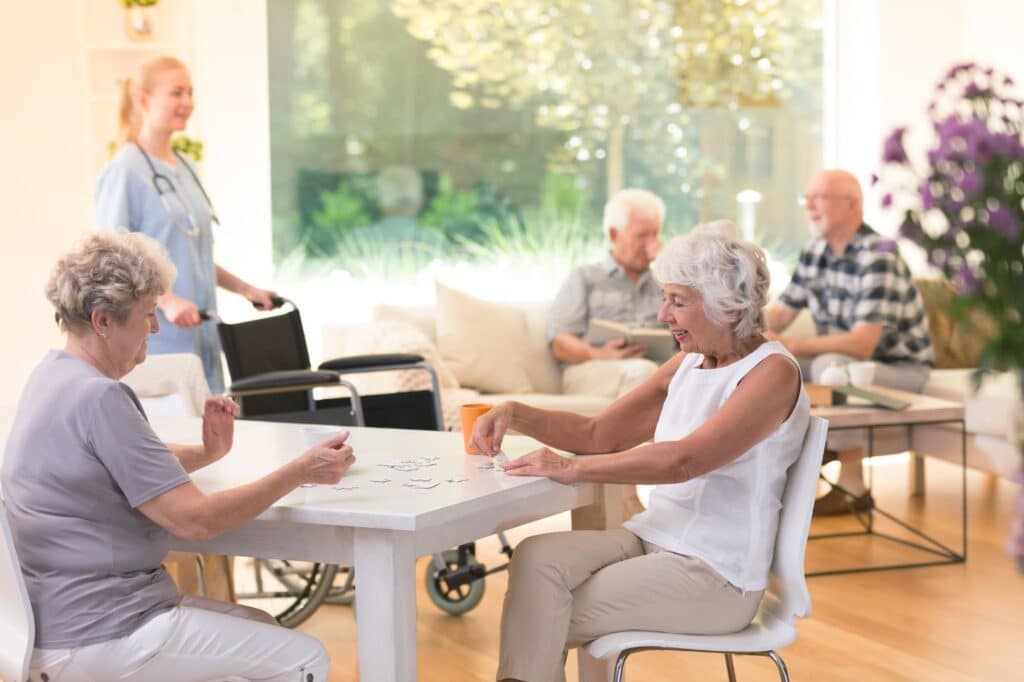 The Legacy At Falcon Point | A group of seniors playing cards together in their assisted living community.