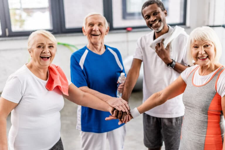 Pegasus Senior Living | Seniors huddled up after group activities