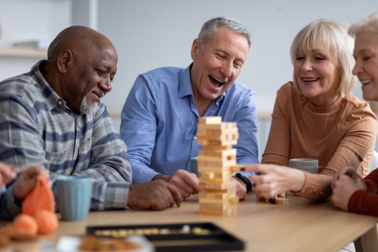 The Legacy at Long Meadow in Richmond | Seniors playing jenga and laughing