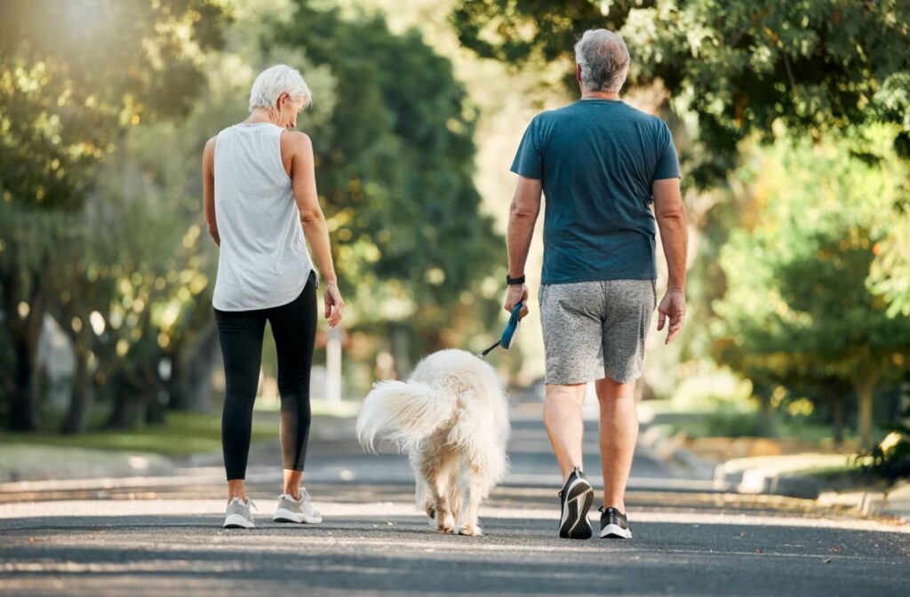 The Legacy at Long Meadow in Richmond | Senior couple walking their dog