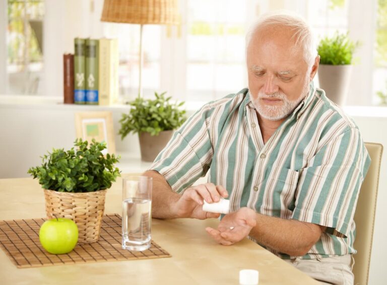 The Legacy at Long Meadow in Richmond | Senior man taking his medicine