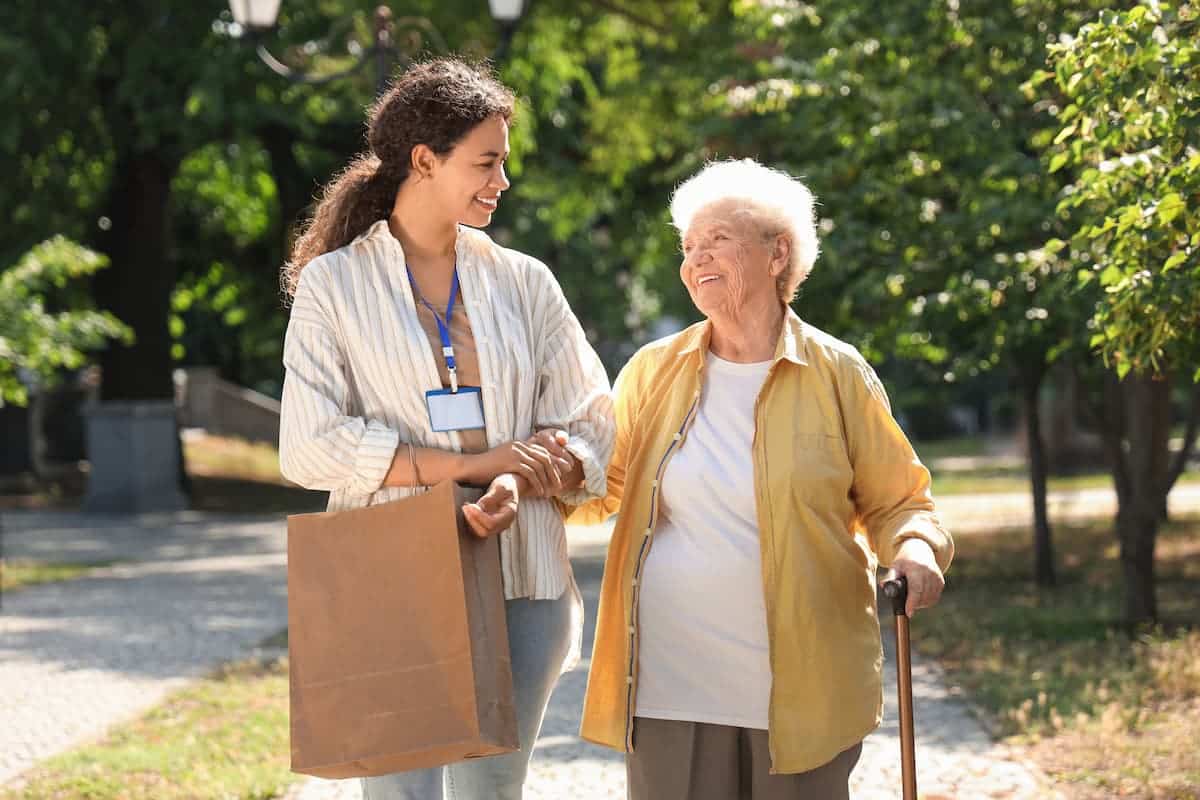 The Legacy at Town Square | Senior getting help walking