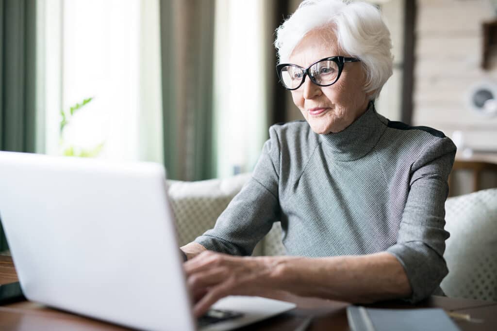 The Village at Rancho Solano | Senior woman using laptop