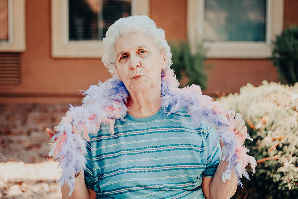 Pegasus Senior Living | Senior woman with boa