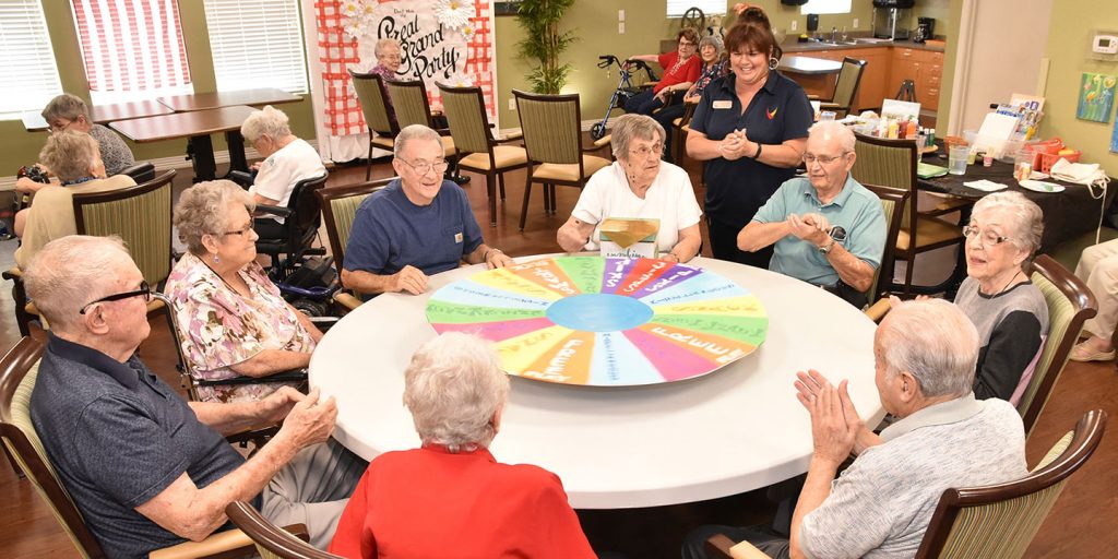 Pegasus Senior Living | Teresa Hadley, Life Enrichment Director, leads a group of residents in a game at Pegasus Landing of Mesa, Mesa, AZ