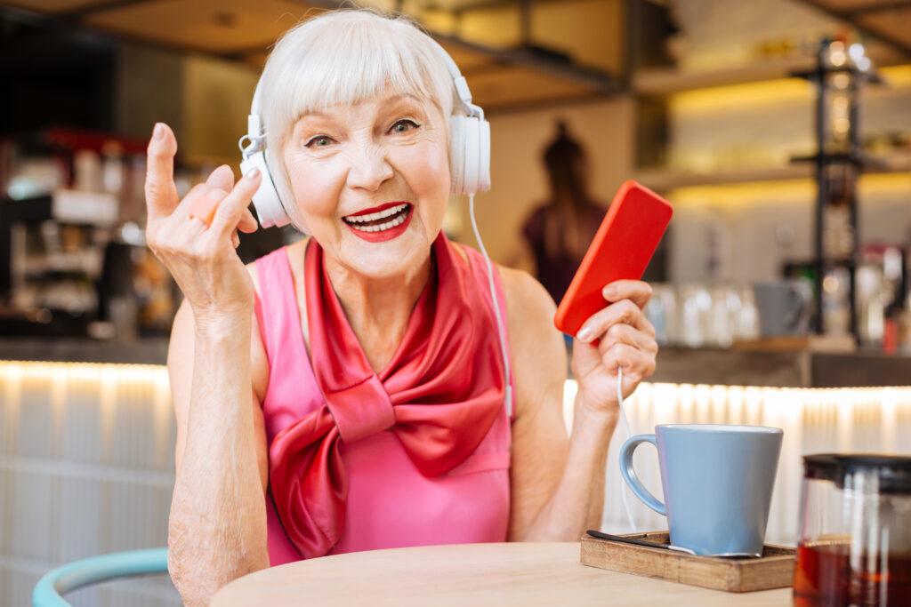 Pegasus Senior Living | Cheerful positive woman enjoying rock music