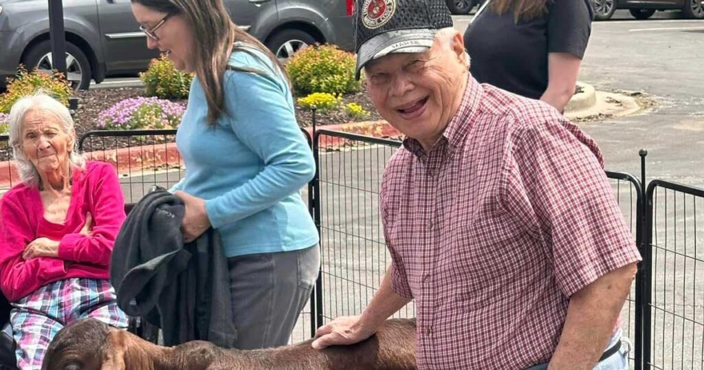 Glenwood Village of Overland Park | Senior man petting goat