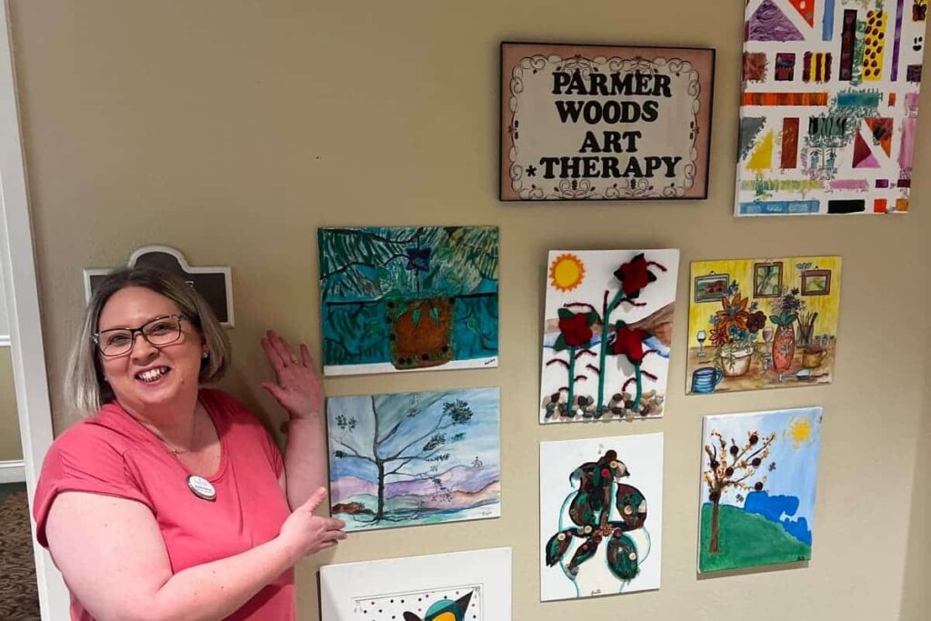 Parmer Woods at North Austin | Brandy showing off the residents' artwork