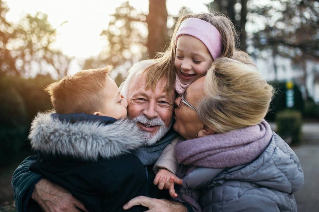 The Courtyards at Mountain View | Grandparents getting hugs from their grandkids