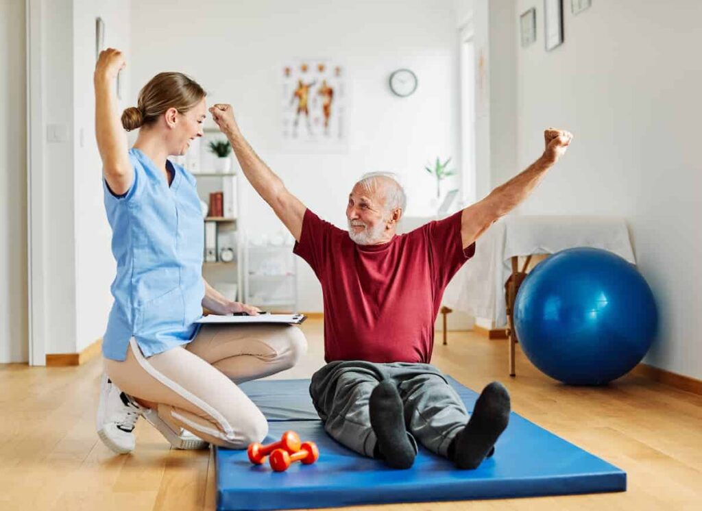 Creston Village | California memory care - senior man doing floor exercise with caregiver