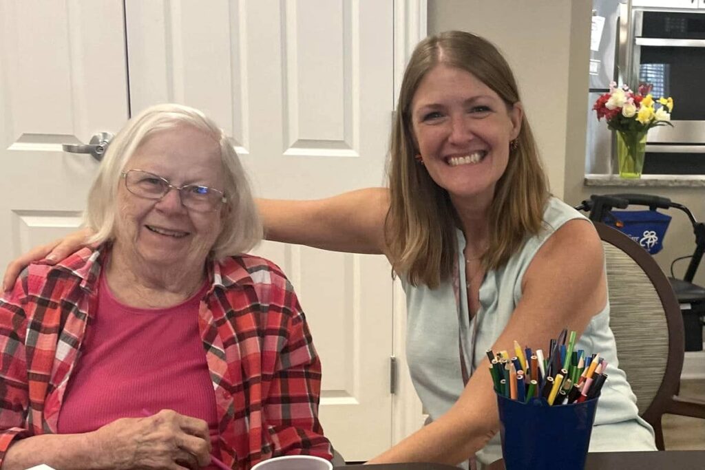 Courtyards at Mountain View | Molly sitting with a memory care resident