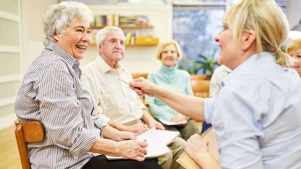 Pegasus Landing of Mesa | Group of happy seniors playing a group memory care game