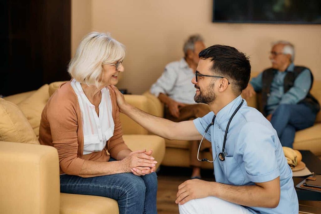 The Courtyards at Mountain View | Senior woman talking to a caregiver about memory care